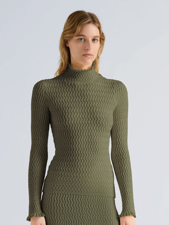 Proenza Schouler Front cropped image of model wearing Juniper Sweater in Cable Knit in Dark Olive