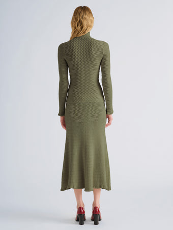 Proenza Schouler Back full length image of model wearing Juniper Sweater in Cable Knit in Dark Olive