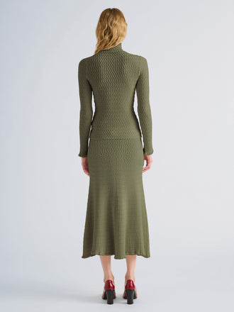 Proenza Schouler Back full length image of model wearing Juniper Sweater in Cable Knit in Dark Olive