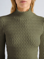 Proenza Schouler Detail image of model wearing Juniper Sweater in Cable Knit in Dark Olive