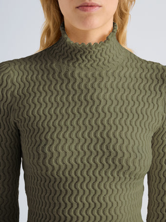 Proenza Schouler Detail image of model wearing Juniper Sweater in Cable Knit in Dark Olive