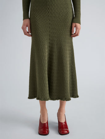Proenza Schouler Detail image of model wearing Magnolia Skirt in Cable Knit in Dark Olive
