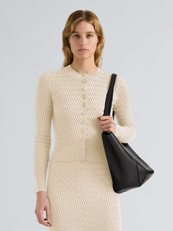 Proenza Schouler Front cropped image of model wearing Marci Cardigan in Cable Knit in Vanilla