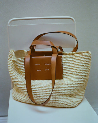 Large Morris Tote in Raffia in ivory sitting on white metal chair