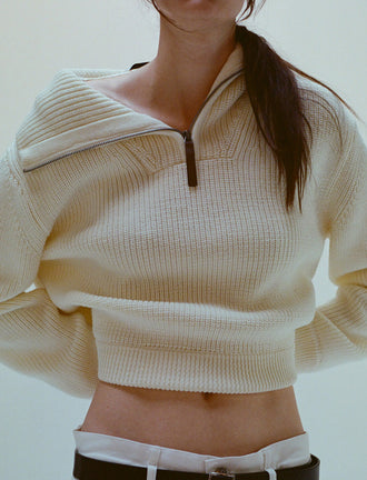Cropped image of model wearing Sienna Sweater in Wool in off white and Ellsworth Jean in white
