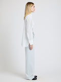 Proenza Schouler Side full length image of model wearing the Weyes Pant in Cotton Viscose Suiting in Pale Grey