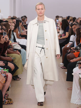 Runway image of model in Billie Coat In Lacquered Leather in ecru