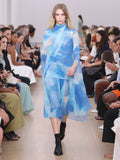 Runway image of model wearing Amber Top In Printed Nylon Jersey in cerulean