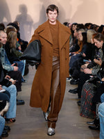 Runway image of model wearing Double Face Llama Wool Coat in UMBER