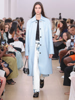 Runway image of model in Billie Coat In Lacquered Leather in pale lapis 