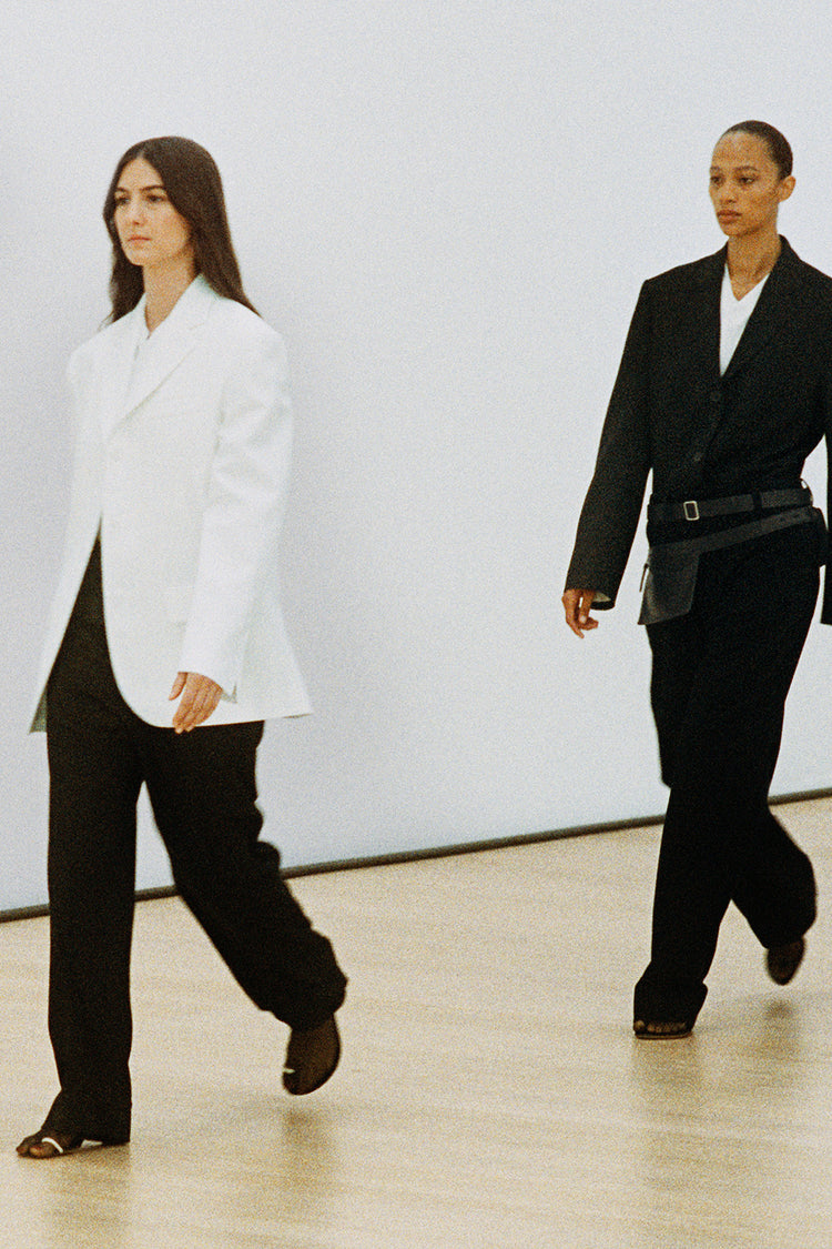 Image from the Proenza Schouler Spring 2024 Runway Show featuring Weyes Blood and Selena Forrest in a white and black suit