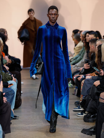 Model in Cobalt Ice Dyed Velvet Shirt Dress, Black Cone Over The Knee Boots, Black Bar Bag, and Black Leather Gloves