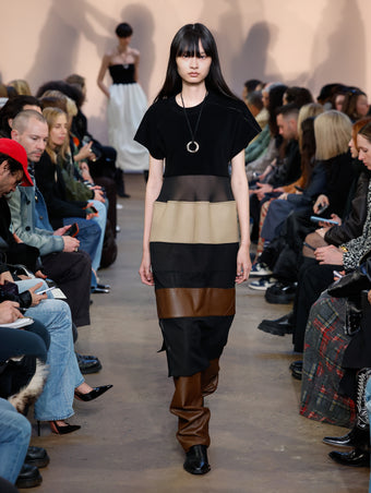 Model in Black Multi Multi-Media Dress, Chestnut Nappa Leather Pant, Black Bronco Ankle Boots, and Gold/silver Ring Necklace