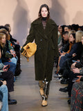 Runway image of model wearing Melange Wool Boucle Coat in FAWN